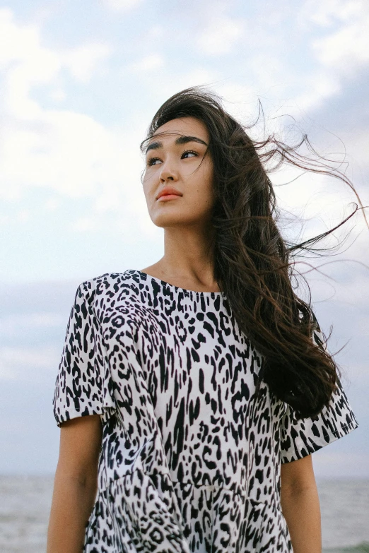 an attractive woman standing on the shore line