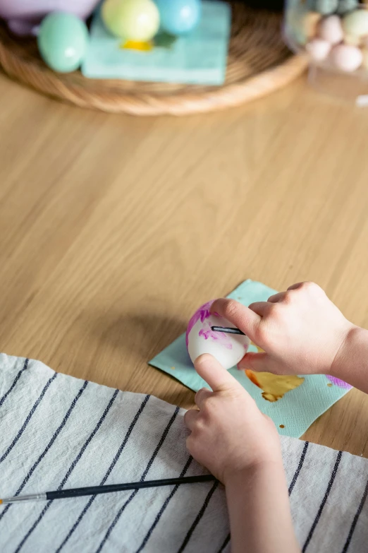 child doing a craft work on an easel