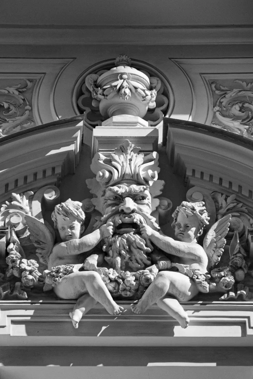 a decorative gargoyle adorns the entrance to a building