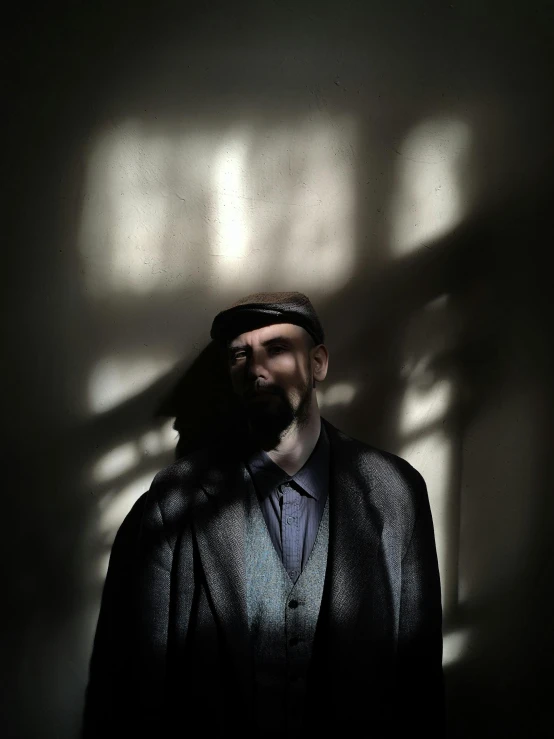 a man with a beard, jacket and tie posing for a picture