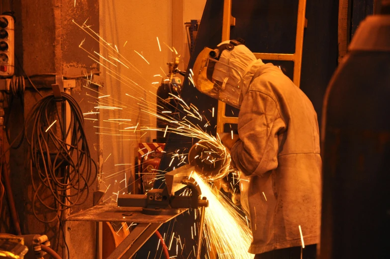 man welding the back end of an industrial machine