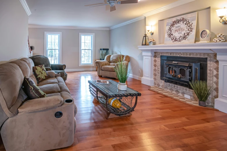 an interior po with couches, table, chair and fireplace