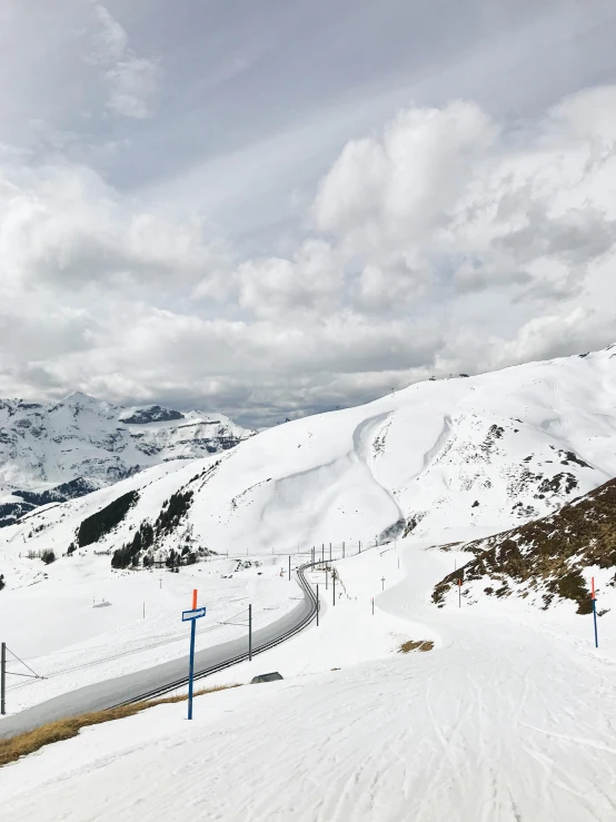 this is a snowy hill with a few snowboards