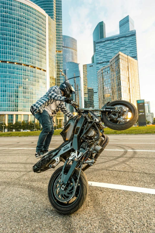 the man is jumping his bike in front of the city