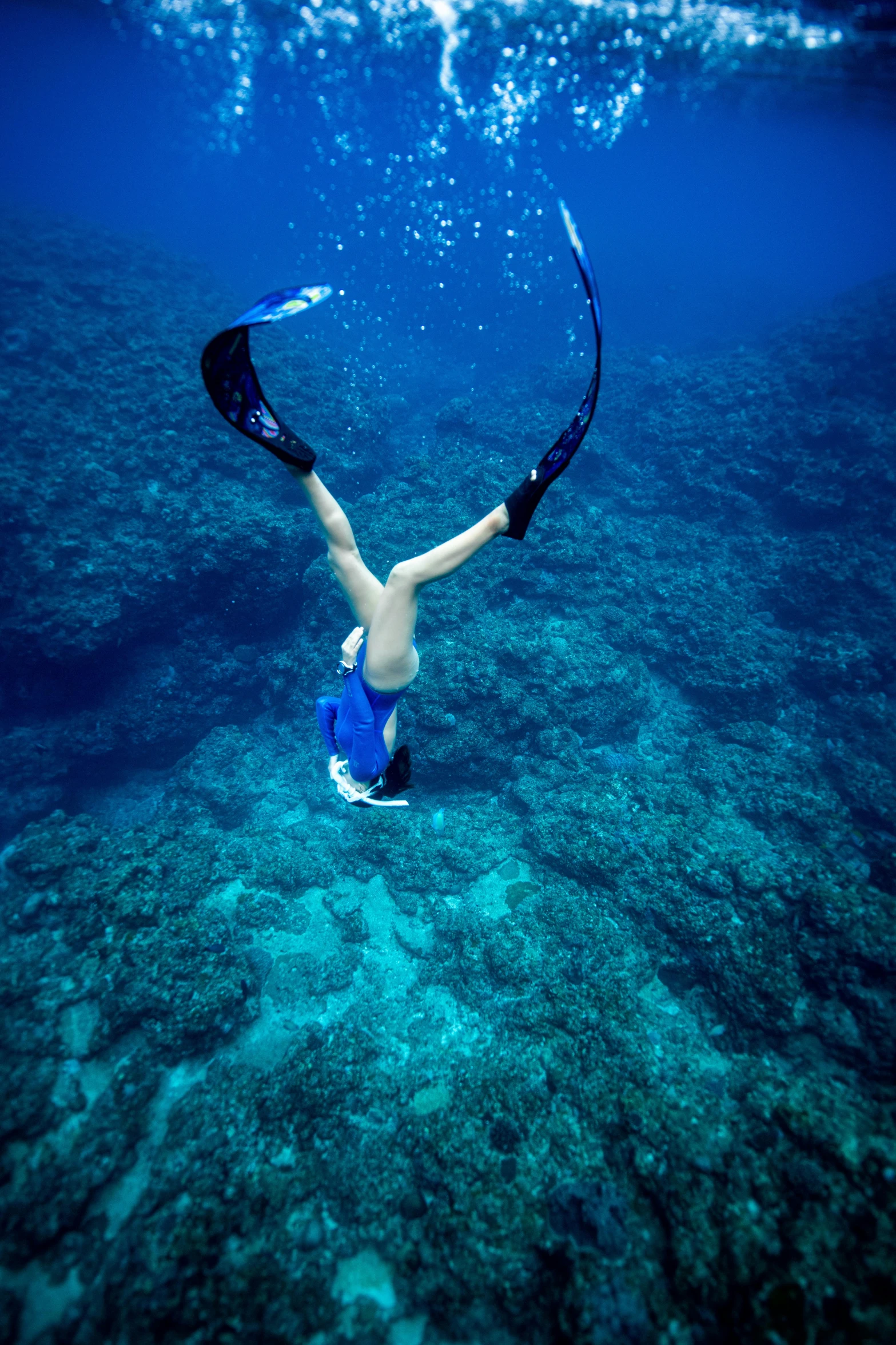 a person is diving with some equipment in the ocean