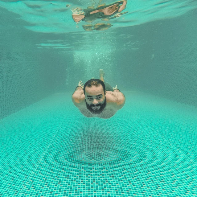 a person swimming in the blue water