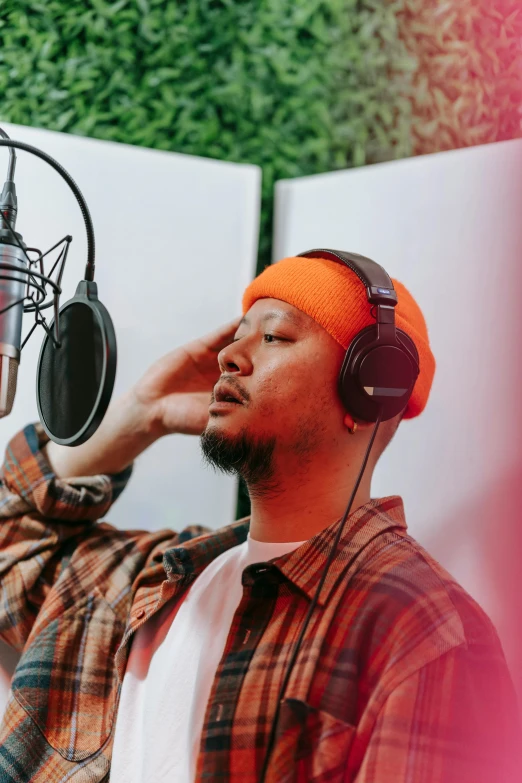 the man is listening to music in his home studio