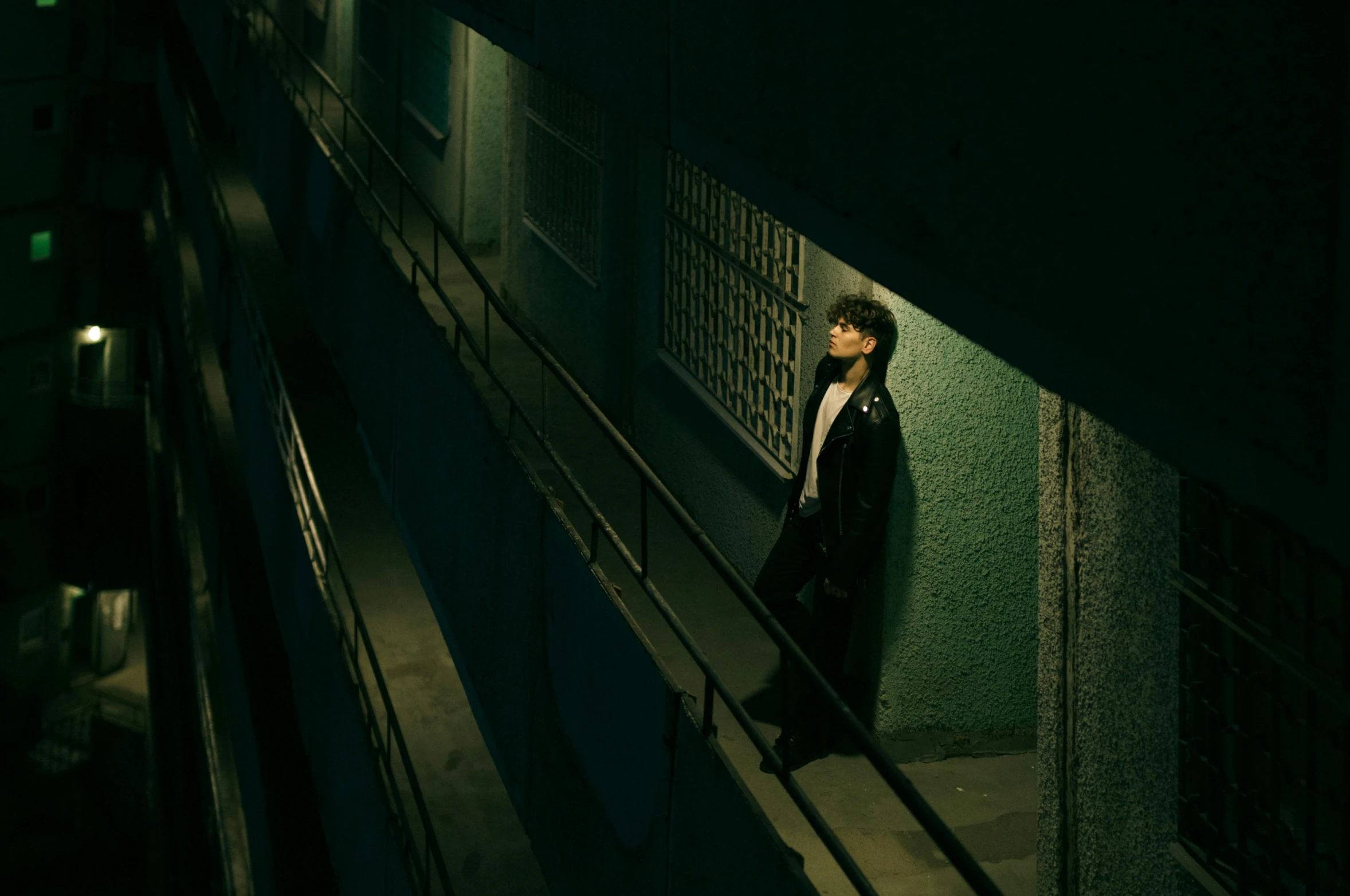 a woman standing next to a glass window in an elevator