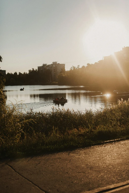 the sun is setting in the distance over a river