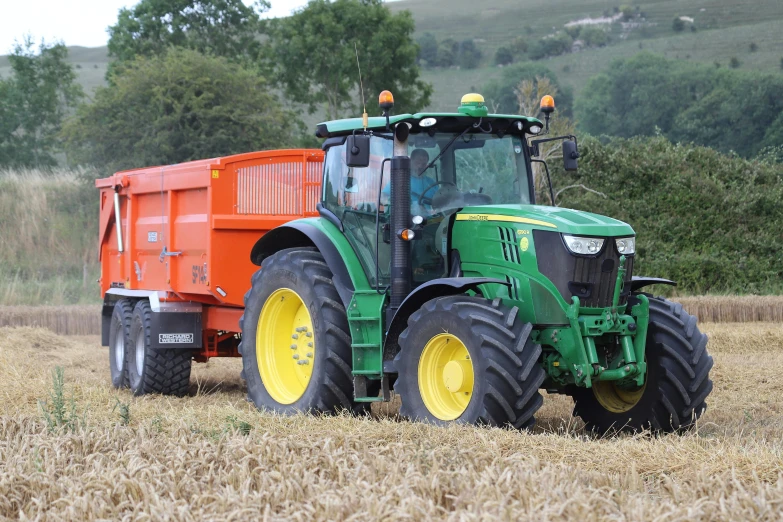 tractor in field with hay bales on bale