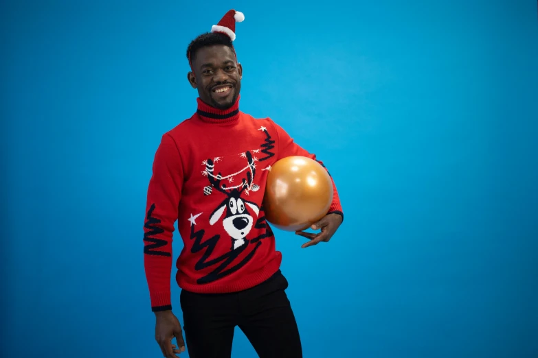 a man standing with a golden balloon in his hand