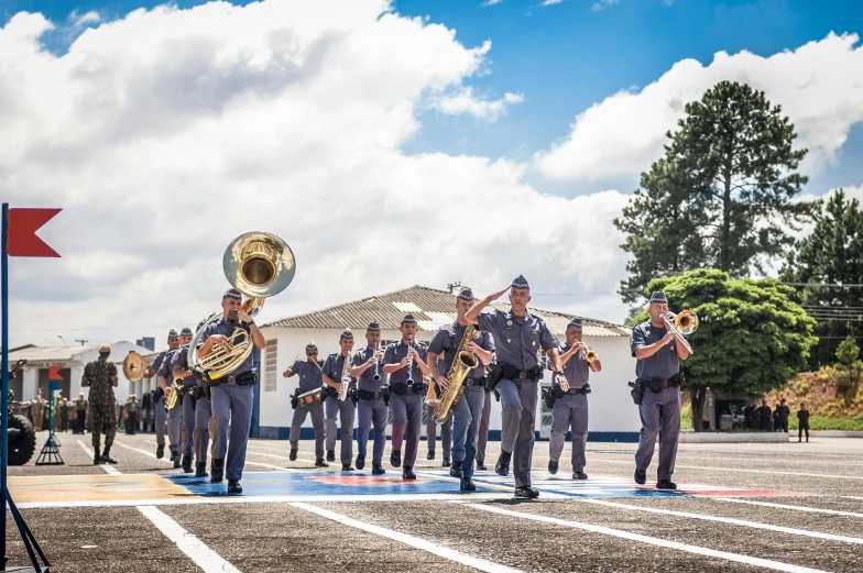 some military personnel are playing instruments in front of a building