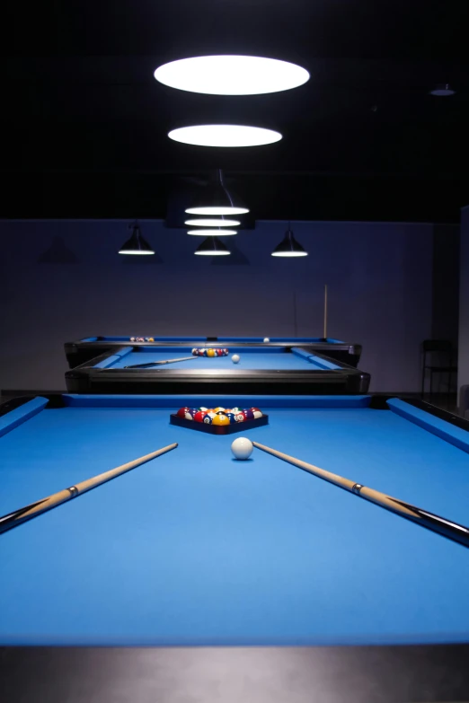 a pool table is illuminated by light bulbs