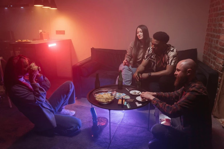 a group of young people eating out of a table