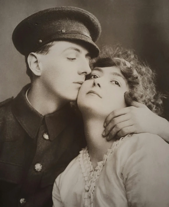 an old fashion po shows a young man kissing the face of a woman