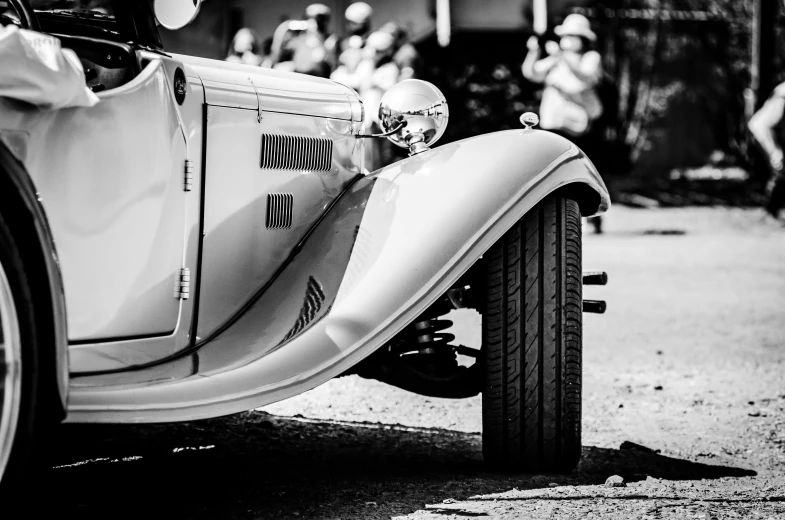 vintage car with driver inside sitting in a lot