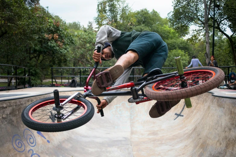 a man riding a bike up the side of a ramp