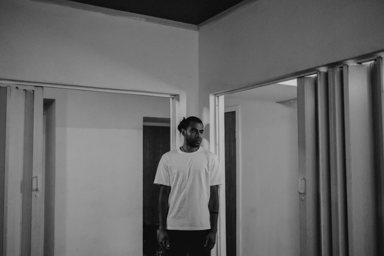a man standing in a mirror next to a room