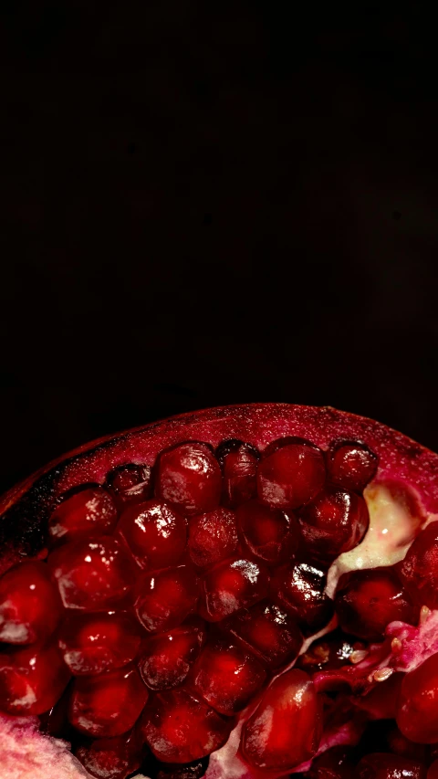 a picture of a pomegranate in the dark