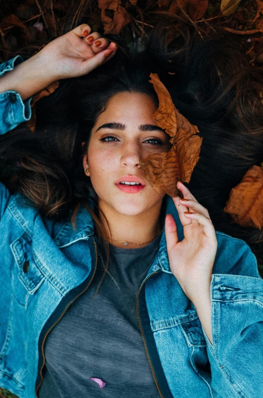 a woman in a jean jacket and sunglasses