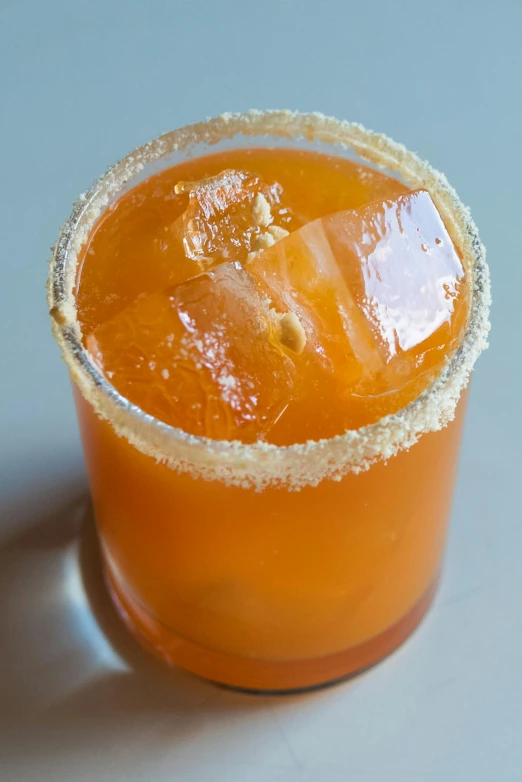 a beverage garnished with sugar on a white table