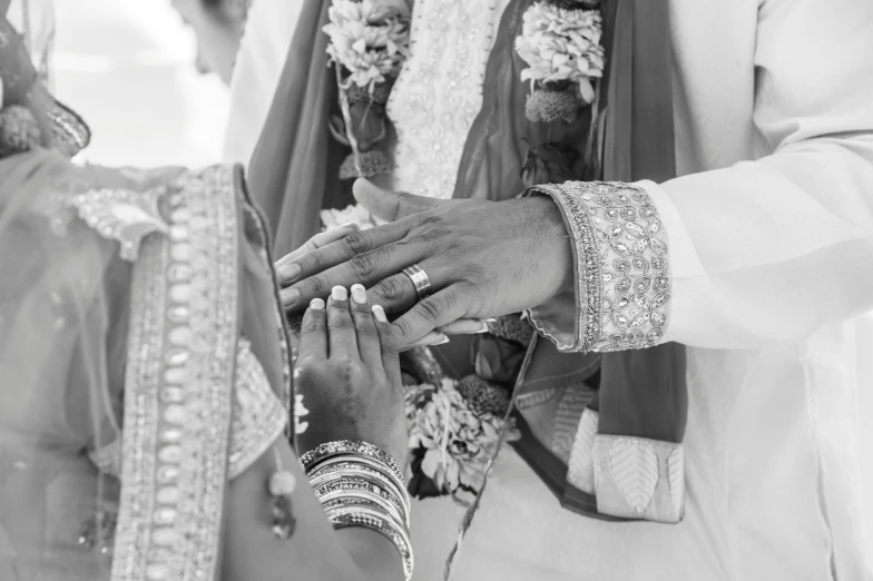 couple with hands clasped during wedding ceremony