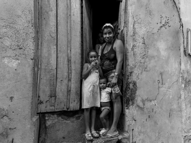 two small children standing in an open door of a building