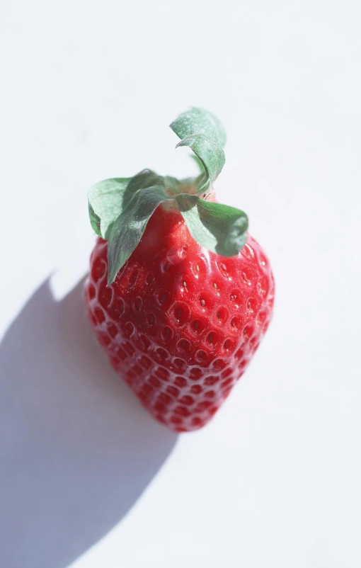 a strawberry is shown with a green leaf in it