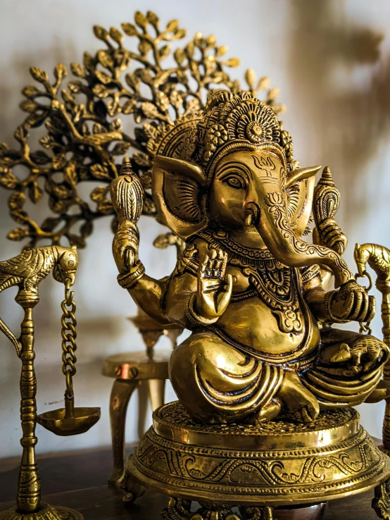 an elephant statue made out of ss, standing by some decorative items