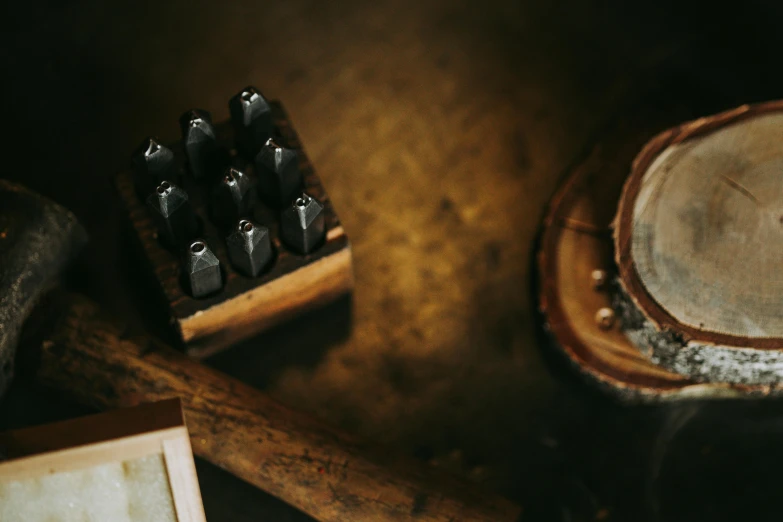 an old wooden and rubber drum, two wood pegs and a frame