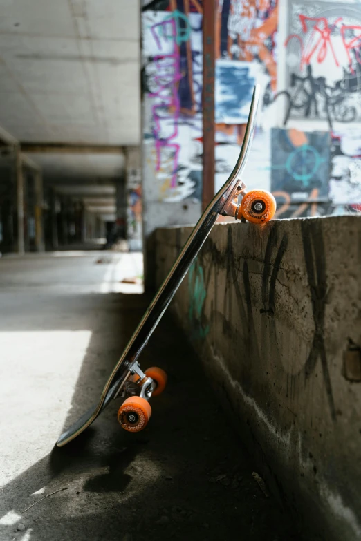 a skateboard resting on top of a graffiti covered building