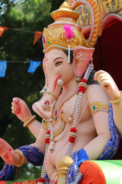 the statue of an indian god is adorned with beads