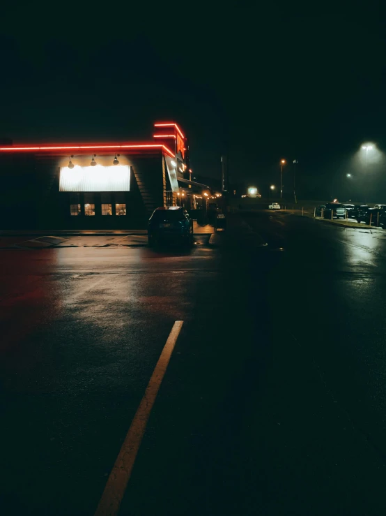 a dark picture of cars on a city street