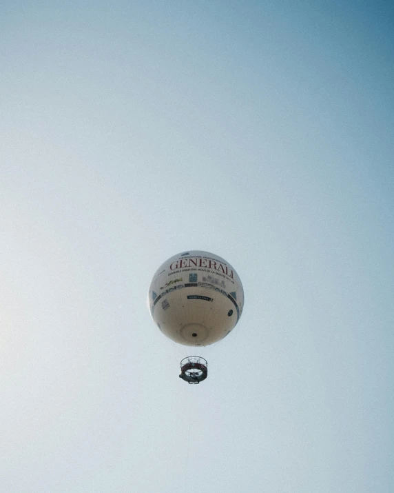 a large white air ballon flies in the sky