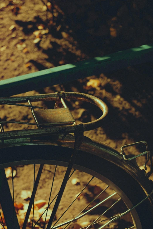 a bicycle with no wheels sits parked next to a green bench