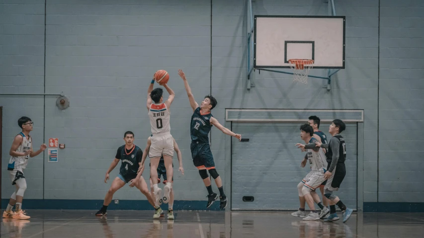 a basketball player tries to block the ball as he goes for it