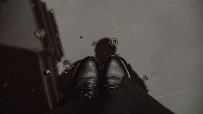 a person's shoes standing on top of a door