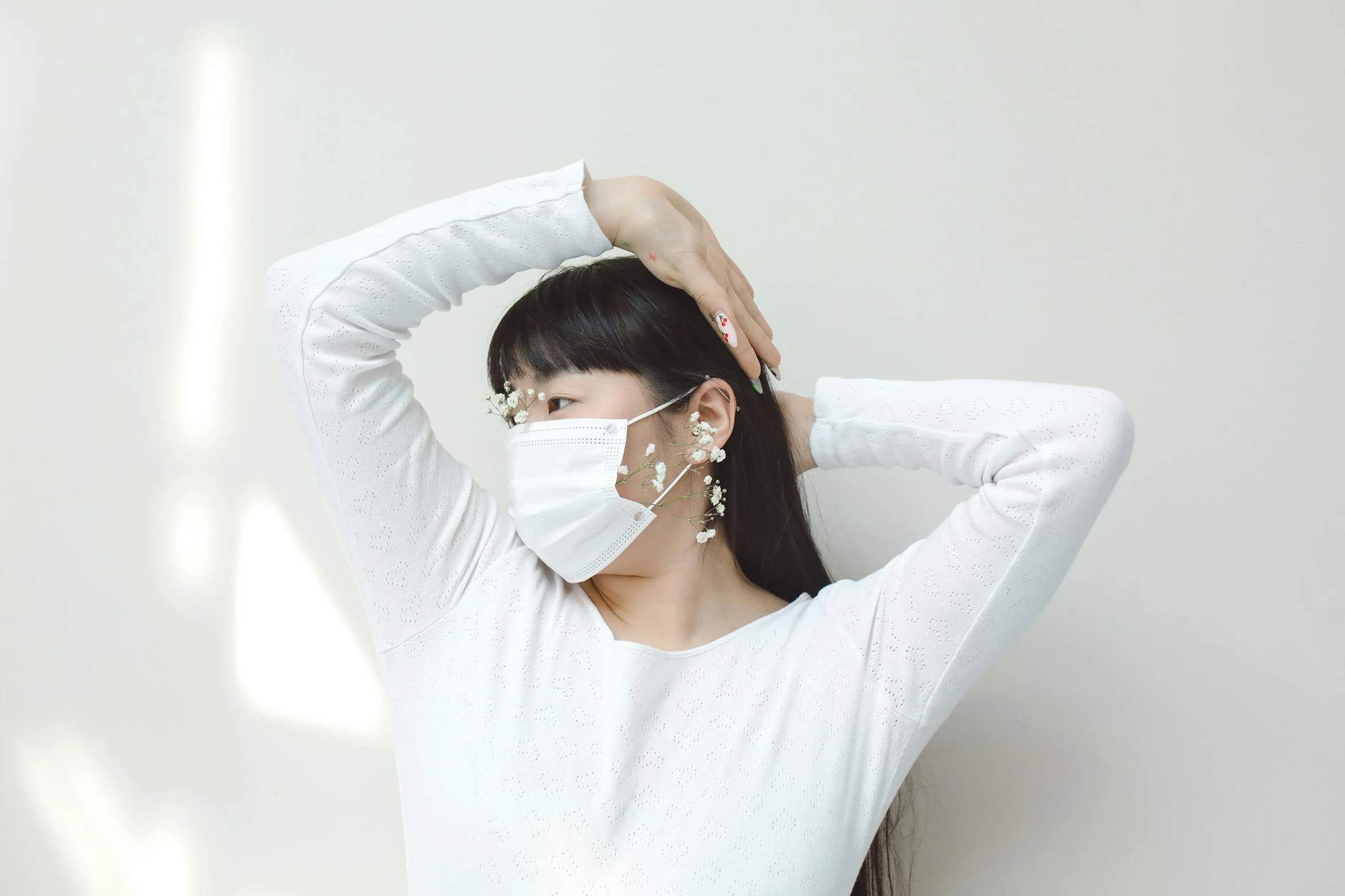 a woman wearing a face mask covering her ears