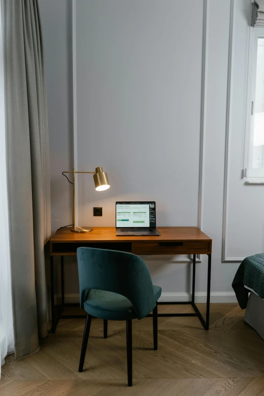 a laptop computer sitting on a wooden desk