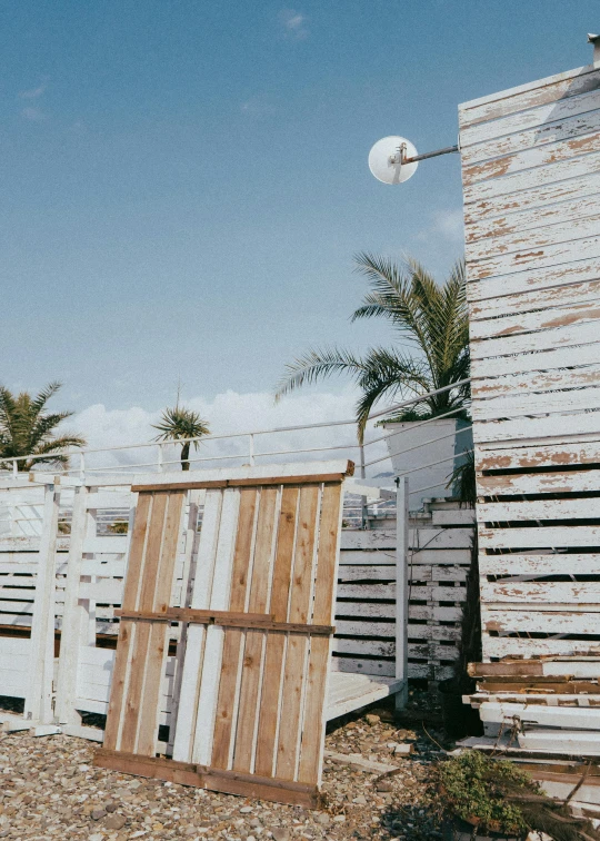 a wooden barn with a light in the background