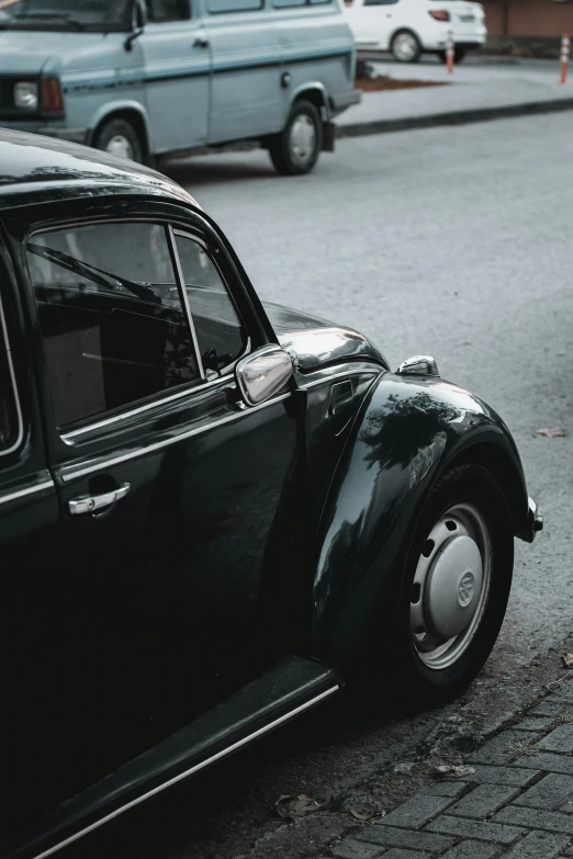 an old vintage style car sitting on the side of the road