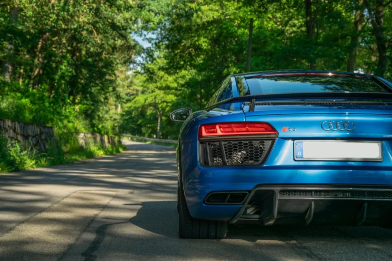 the tail end of an older blue audi sports car