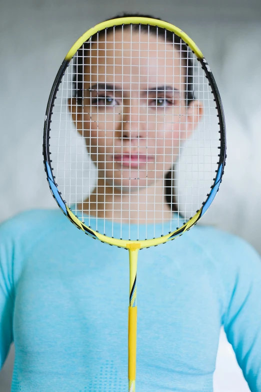 a woman holding a tennis racquet in her hand