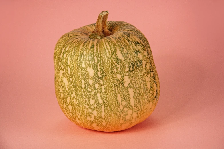 an image of a green apple on a pink background