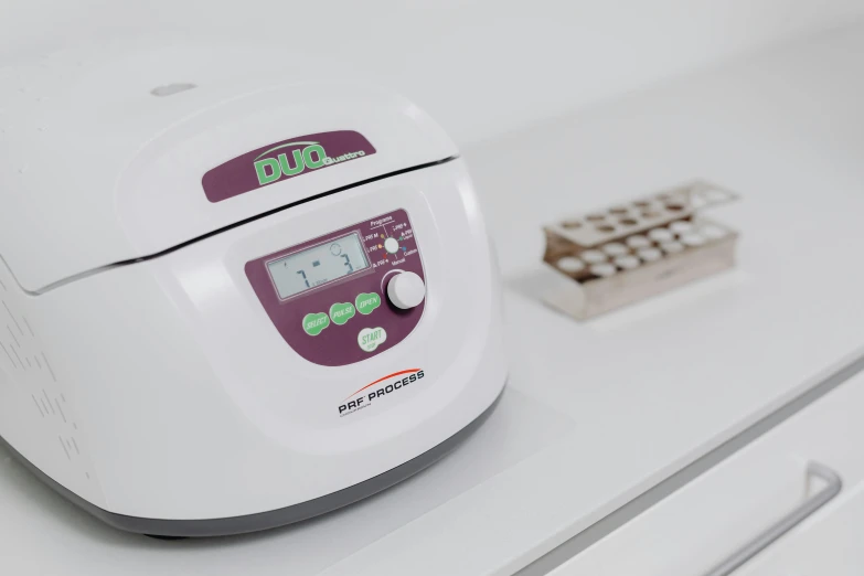 an electronic clock and thermometer sitting on top of a counter