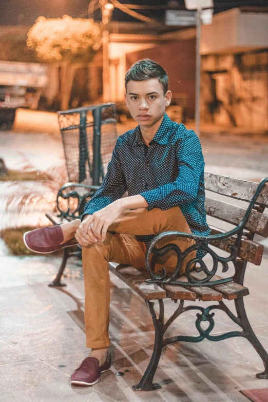 man sitting on a bench in front of the street