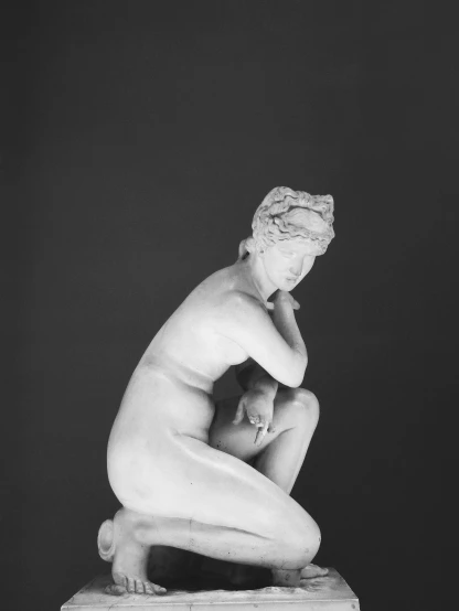 the sculpture has a female figure on its knees