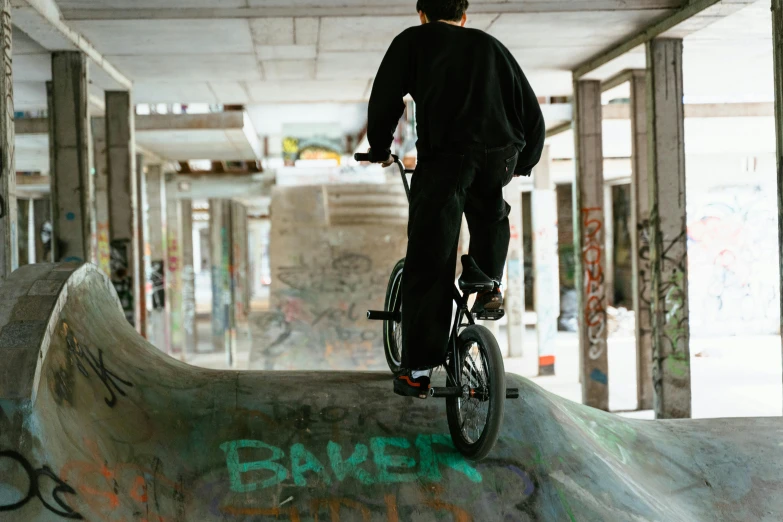 a man is riding a bike at a skate park
