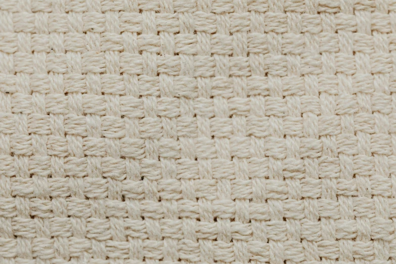 white wool and jute textured surface with black dots