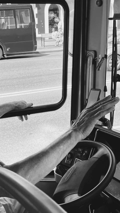 man driving bus with hands on steering wheel